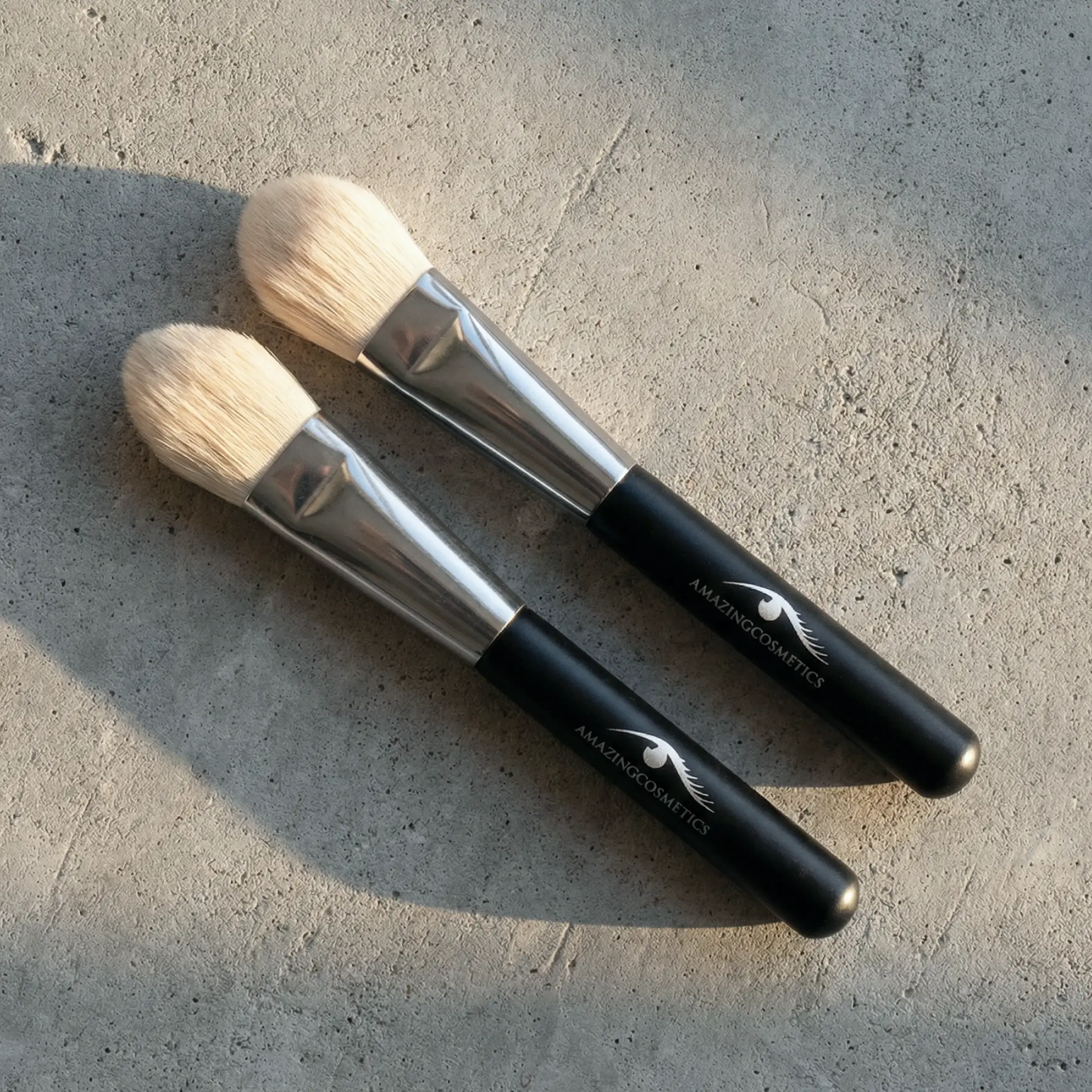 Foundation brushes by AmazingCosmetics; 3 beige-bristled brushes with black handles.