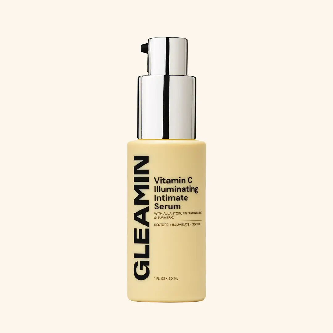 Illuminating Intimate Serum by Gleamin; body oil in beige bottle with silver pump.
