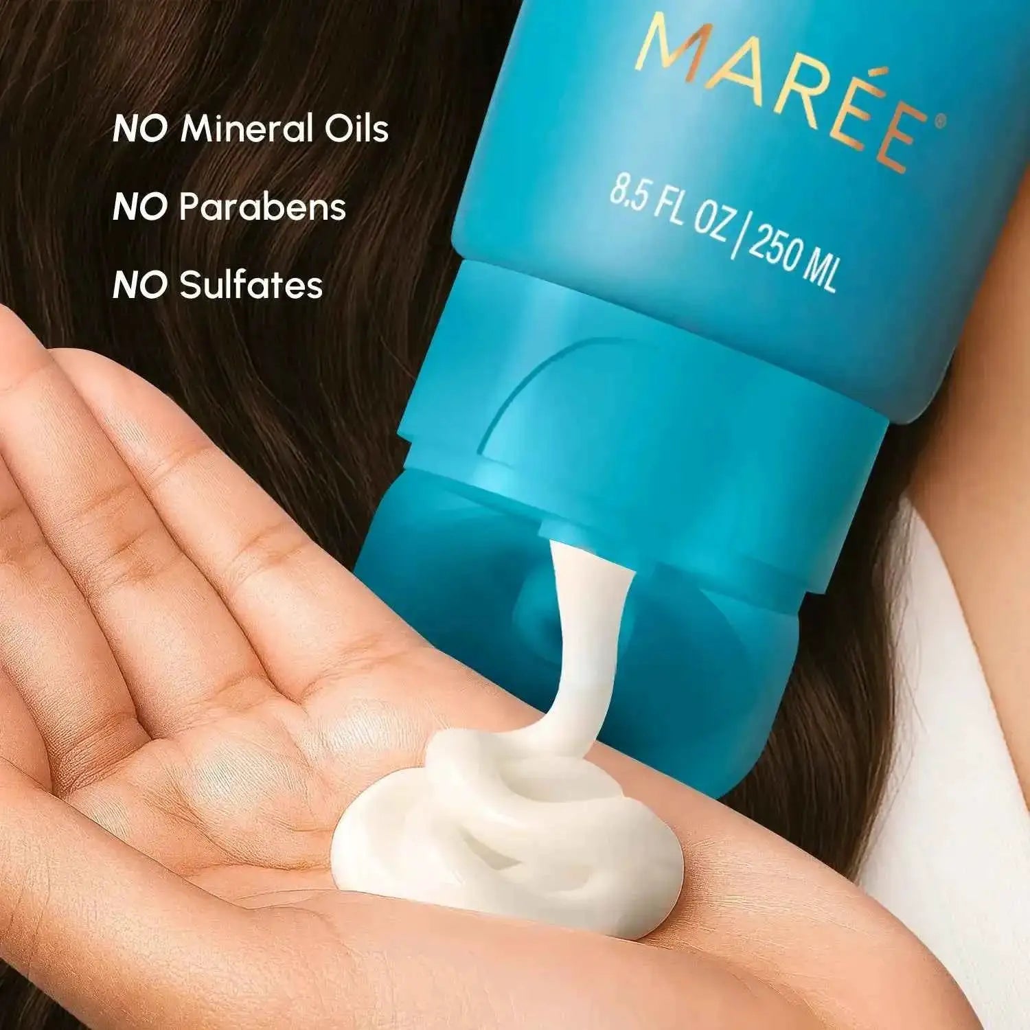 Deep Hydrating Coconut Conditioner by Maree; turquoise bottle pouring white conditioner into the palm