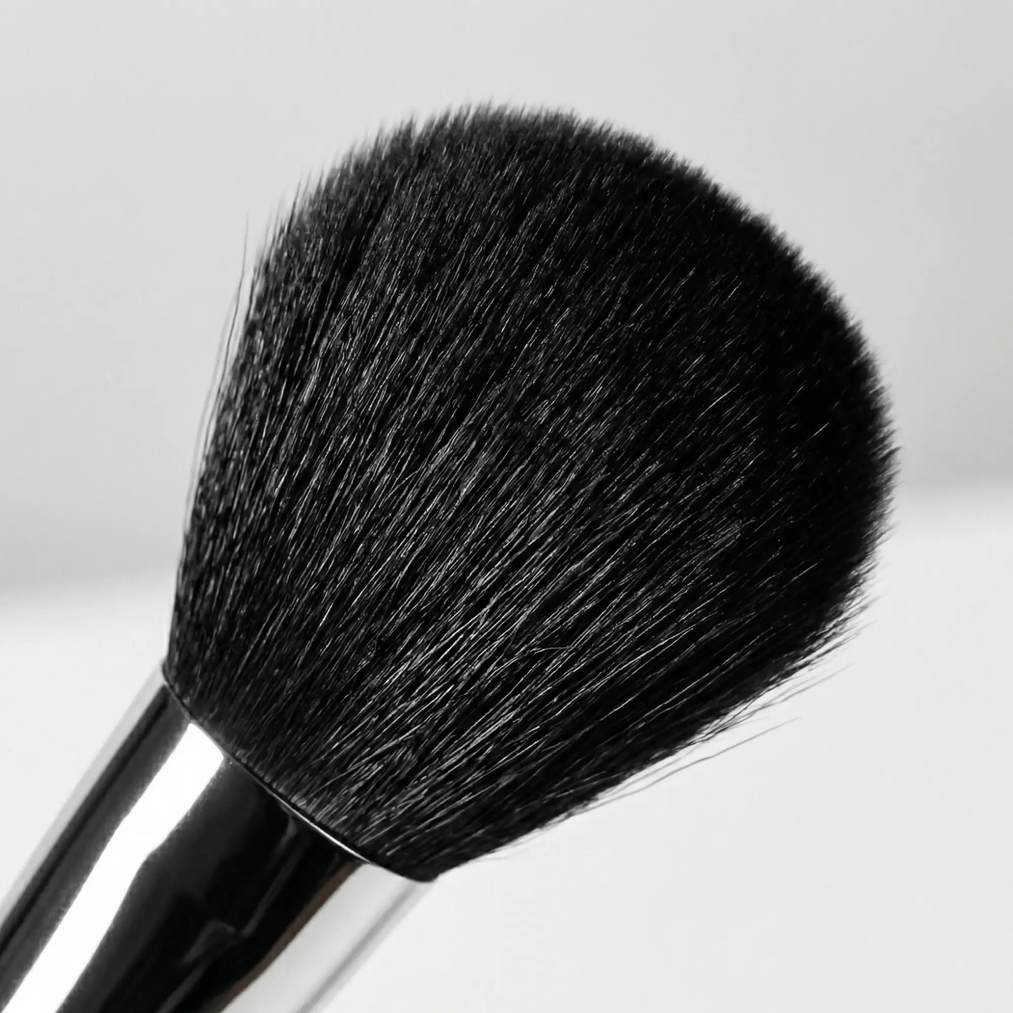 Velvet Brush makeup tool with black bristles and silver ferrule