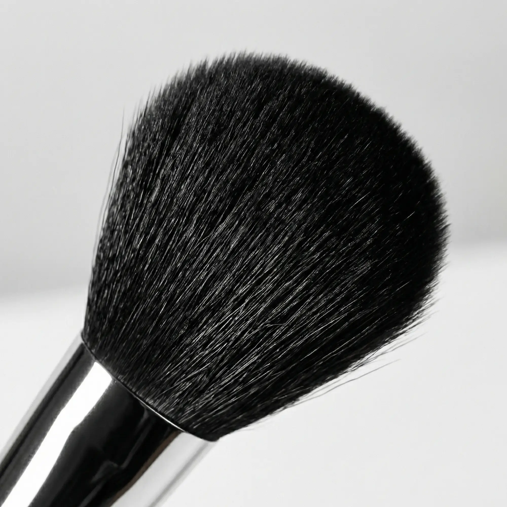 Velvet Brush makeup tool with black bristles and silver ferrule