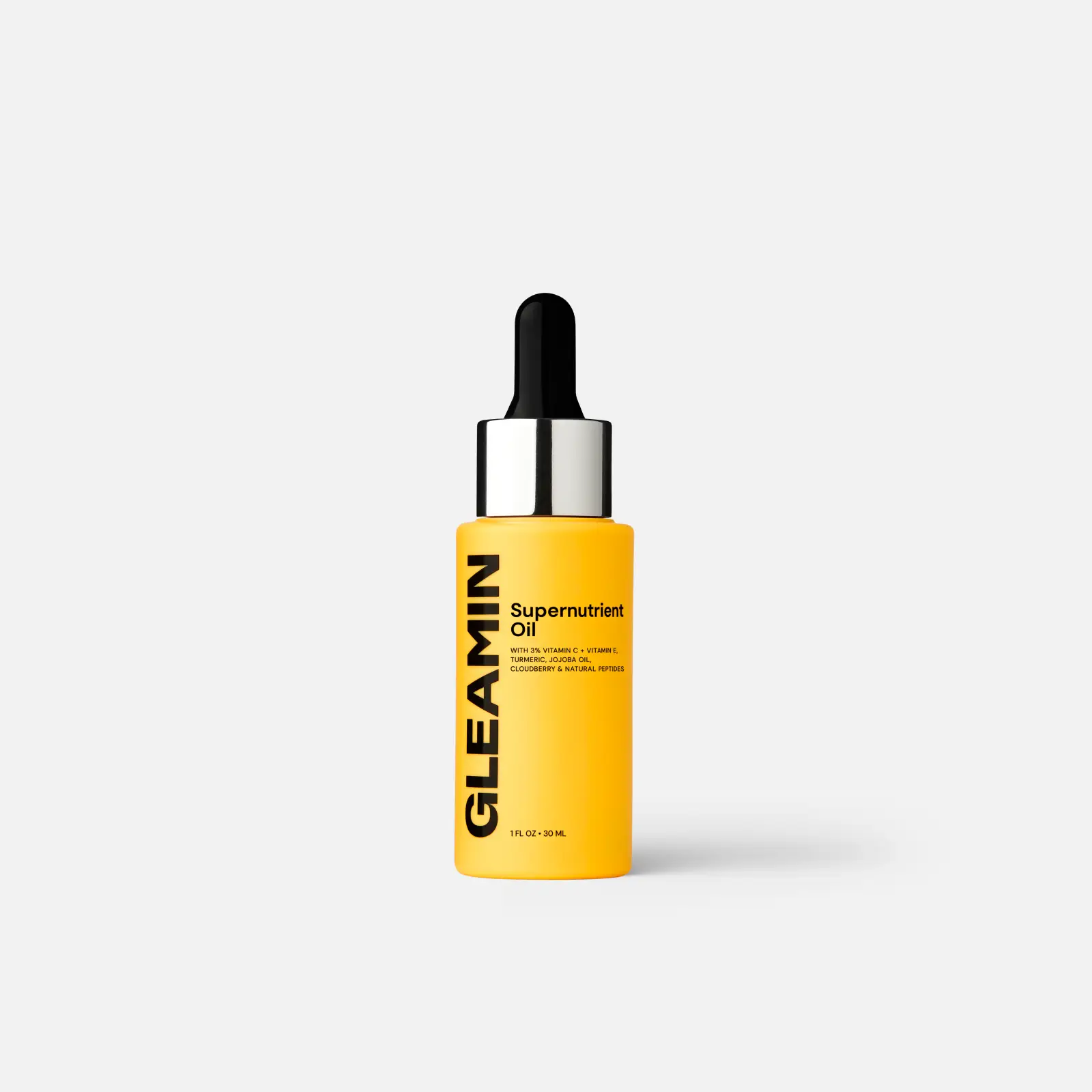 Gleamin Supernutrient Oil face oil bottle, yellow-orange with black dropper cap